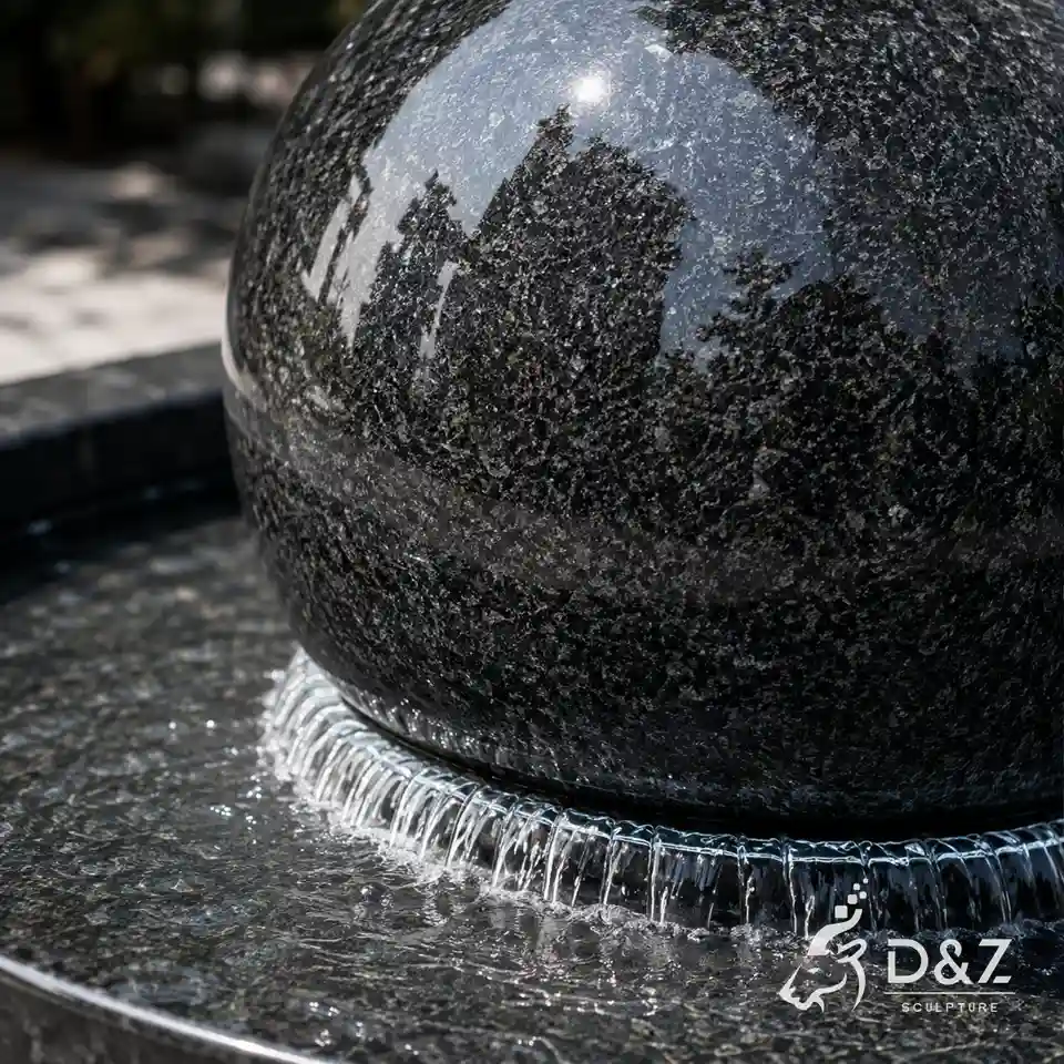 Close-up of polished granite sphere and flowing water film Close-up of polished granite sphere and flowing water film